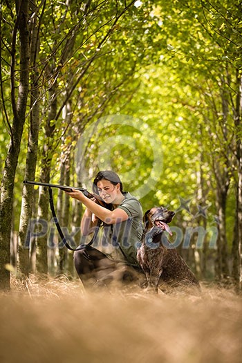 Autumn hunting season. Hunting. Outdoor sports. Woman hunter in the woods Autumn hunting season. Hunting. Outdoor sports. Woman hunter in the woods