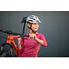 Pretty, young woman biking on a mountain bike enjoying healthy active lifestyle outdoors in summer (shallow DOF)