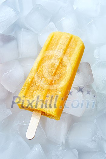 Natural frozen peach smoothies on a stick on ice cubes. Dietary cold dessert. Top view