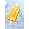 Natural frozen peach smoothies on a stick on ice cubes. Dietary cold dessert. Top view