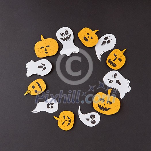 Round creative frame of colorful paper with handmade laughing flying ghosts, spirits, scary pumpkins on a black background, place for text. Halloween concept. Flat lay. Round creative frame of colorful paper with handmade laughing flying ghosts, spirits, scary pumpkins on a black background, place for text. Halloween concept. Flat lay.