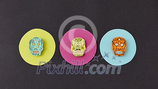 Decorative pattern from round frames with creative handmade skulls on a black paper background. Flat lay. Calaveras simbol of the Mexican holiday of Calaca. Flat lay Decorative pattern from round frames with creative handmade skulls on a black paper background. Flat lay. Calaveras simbol of the Mexican holiday of Calaca. Flat lay