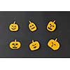 Halloween party handcraft paper pattern of laughing flying scary pumpkins on a black background, place under text. Halloween concept. Flat lay.