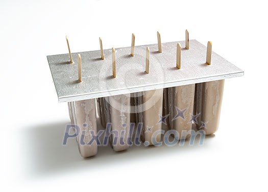 Chocolate ice cream Ice lollies in plastic molds with shadows on white background with space for text. Cooling summer dessert Chocolate ice cream Ice lollies in plastic molds with shadows on white background with space for text. Cooling summer dessert