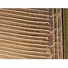 Panoramic from flying drones to an agricultural field after harvesting wheat. Strong strips of land after harvest, natural background. Top view