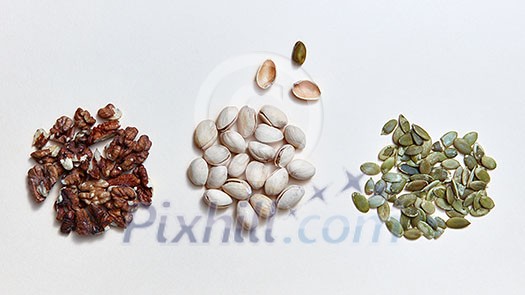 Vegan alternative food, set of various ingredients for vegetarian eating - pistachio, pumpkin seeds, walnuts on a white background, copy space. Flat lay