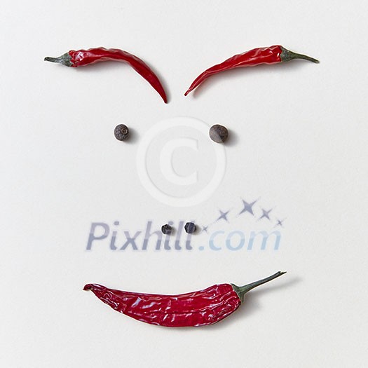A person's face made up of different kinds of peppers - pods of red chili peppers, black and fragrant - nose, eyes, eyebrows, lips on a white background. Food smile concept.