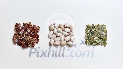 A set of nuts and seeds, natural ingredients for healthy vegetarian natural eating on a white background. Healthy energy vegan snack. Flat lay