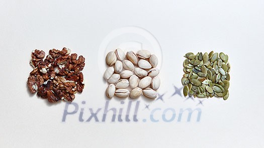 A set of nuts and seeds, natural ingredients for healthy vegetarian natural eating on a white background. Healthy energy vegan snack. Flat lay A set of nuts and seeds, natural ingredients for healthy vegetarian natural eating on a white background. Healthy energy vegan snack. Flat lay