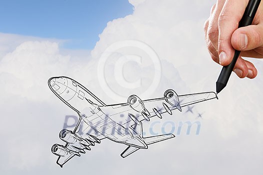 Person drawing airplane model on sky background