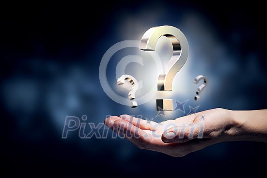 Hand holding question mark in palms on dark background Hand holding question mark in palms on dark background