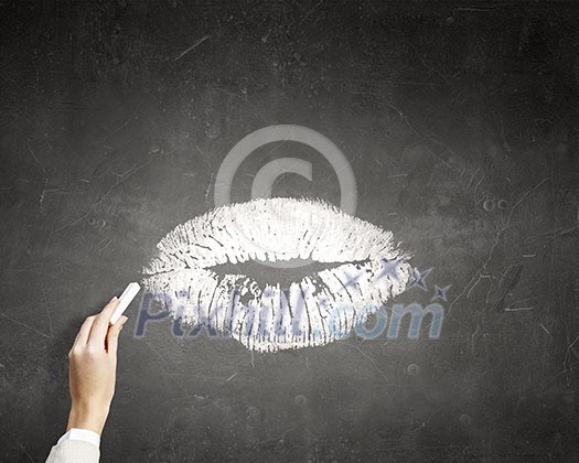 Human hand drawing female lips kiss with chalk Human hand drawing female lips kiss with chalk