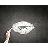 Human hand drawing female lips kiss with chalk