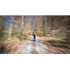 Traveler hiking through deep forest in the mountains - blurred motion techique used to convey fast paced movement