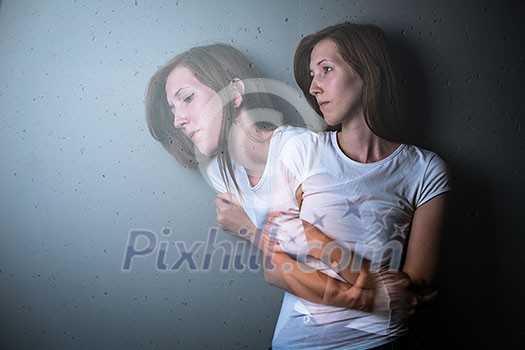 Young woman suffering from a severe depression/anxiety (color toned image; double exposure technique is used to convey the mood of unease, progression of the anxiety/depression) Young woman suffering from a severe depression/anxiety (color toned image; double exposure technique is used to convey the mood of unease, progression of the anxiety/depression)