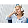 Woman in headphones sitting at desk in office