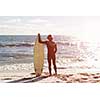 A surfer with his surfboard at the beach