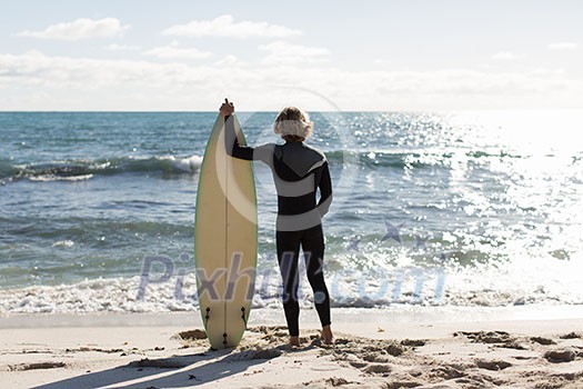 A surfer with his surfboard at the beach A surfer with his surfboard at the beach