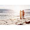 A surfer with his surfboard at the beach
