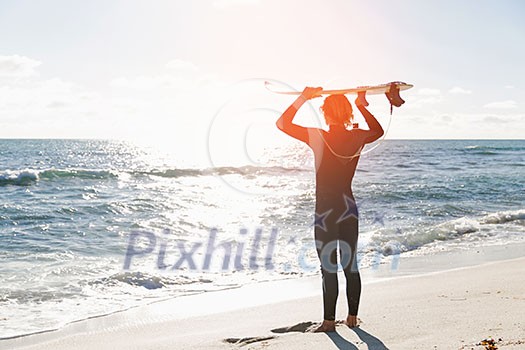 A surfer with his surfboard at the beach A surfer with his surfboard at the beach