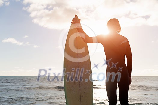 A surfer with his surfboard at the beach A surfer with his surfboard at the beach