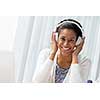 Woman in headphones sitting at desk in office