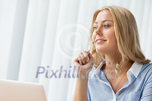 Businesswoman smiling and sitting in offfice Businesswoman smiling and sitting in offfice