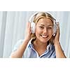 Woman in headphones sitting at desk in office