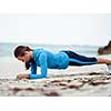 Sporty young woman exercising  on the sea coast