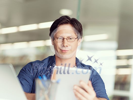 A young businessman working in the office A young businessman working in the office