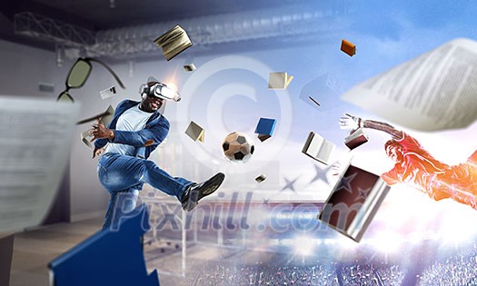 Aframerican man wearing virtual helmet and trying soccer game. Mixed media Aframerican man wearing virtual helmet and trying soccer game. Mixed media