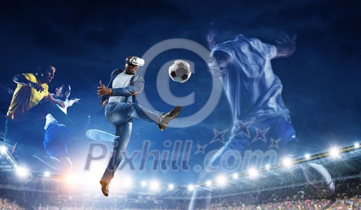 Aframerican man wearing virtual helmet and trying soccer game. Mixed media Aframerican man wearing virtual helmet and trying soccer game. Mixed media