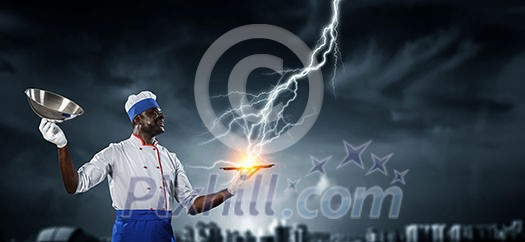 Afroamerican man wearing an apron and cooking hat. Mixed media Afroamerican man wearing an apron and cooking hat. Mixed media