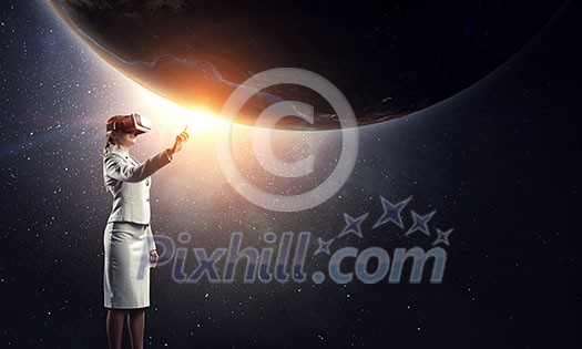 Businesswoman trying virtual reality glasses. Elements of this image are furnished by NASA Businesswoman trying virtual reality glasses. Elements of this image are furnished by NASA