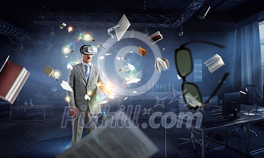 Young businessman wearing virtual helmet. Mixed media Young businessman wearing virtual helmet. Mixed media