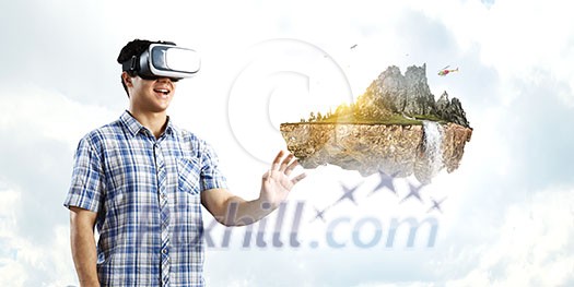 Young man wearing virtual helmet. Mixed media Young man wearing virtual helmet. Mixed media
