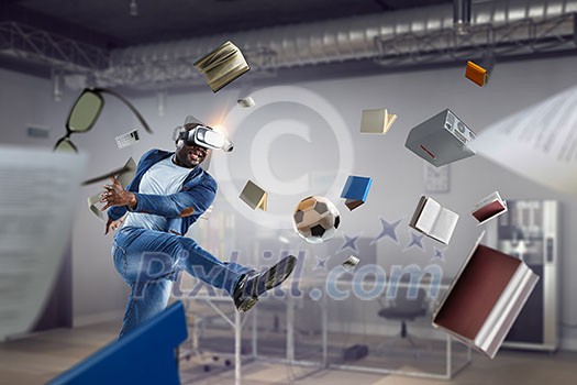Virtual Reality headset on a black male playing football. Mixed media Virtual Reality headset on a black male playing football. Mixed media