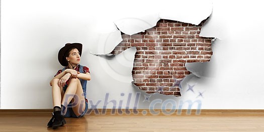 Smiling young beautiful woman sitting on the floor. Mixed media Smiling young beautiful woman sitting on the floor. Mixed media