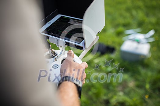 Man Operating a Drone by a Remote Control outdoors Man Operating a Drone by a Remote Control outdoors