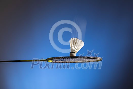 Badminton racket and shuttlecock in motion closeup Badminton racket and shuttlecock in motion closeup