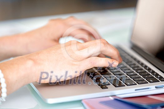 Image of woman's hands typing. Selective focus