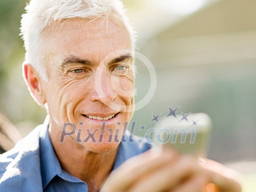 Handsome senior man outdoors using mobile phone