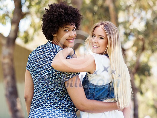 Two women friends in summer park