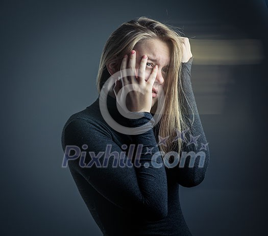 Young woman suffering from a severe stomach pain/depression/anxiety