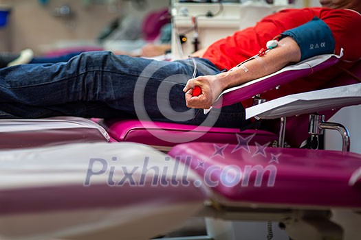 Young woman giving blood in a modern hospital Young woman giving blood in a modern hospital