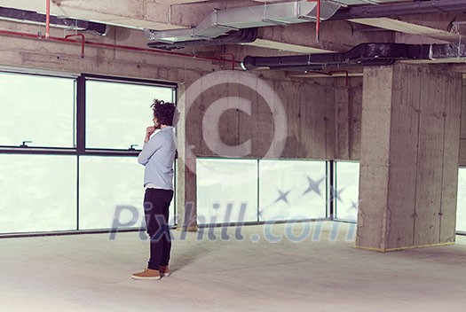 portrait of young male architect on construction site in new startup office