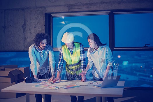 young team of business people in group, architect and engineer on construction site checking documents and business workflow using laptop computer in new startup office