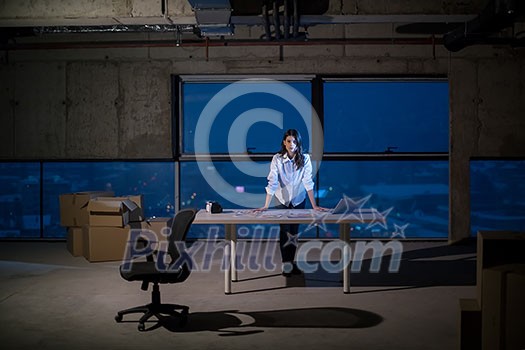 portrait of young female architect on construction site checking documents and business workflow using laptop computer in new startup office