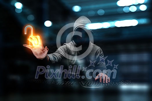Hacker with one hand on keypad, pointing at lighted lock hologram in darkness