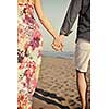 couple on beach with travel bag representing freedom and funy honeymoon concept